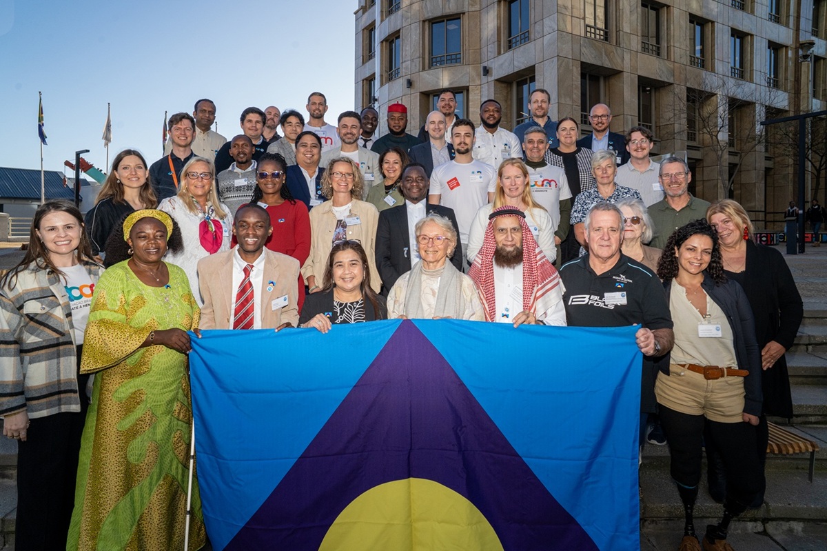 A group photo of CoMO members holding the Meningitis Flag.