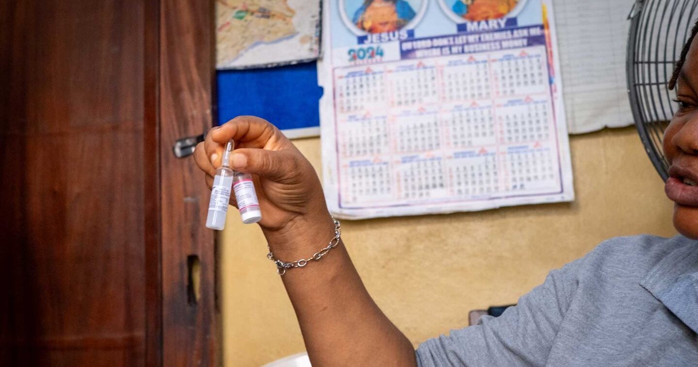 Woman holding a vaccine