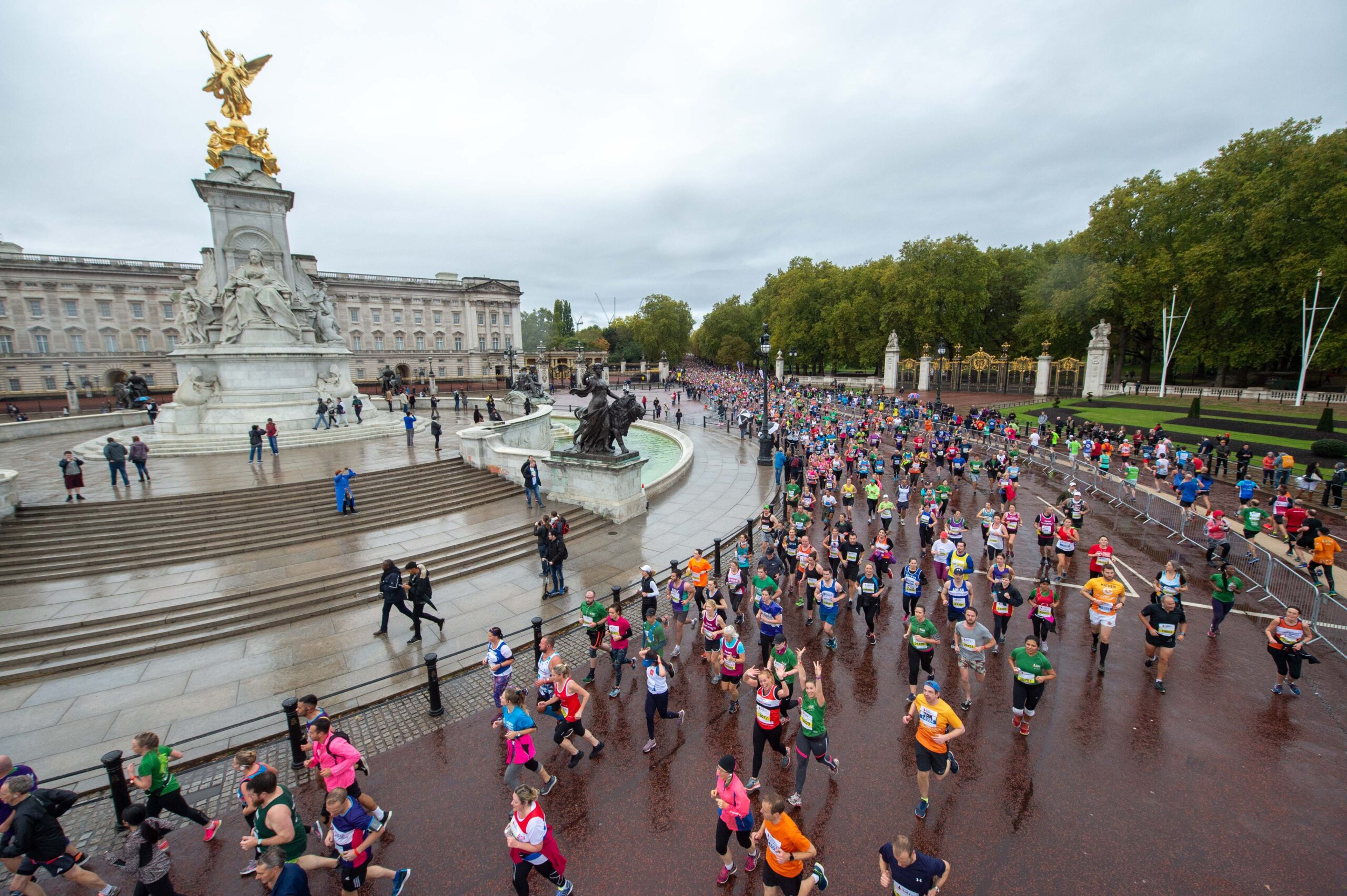 Group of runners pass the Queen Victoria Memorial in central London.