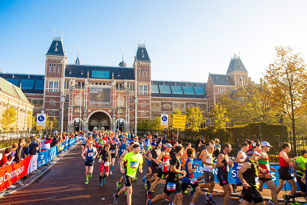 Group of runners pass the Rijkmuseum in Amsterdam.