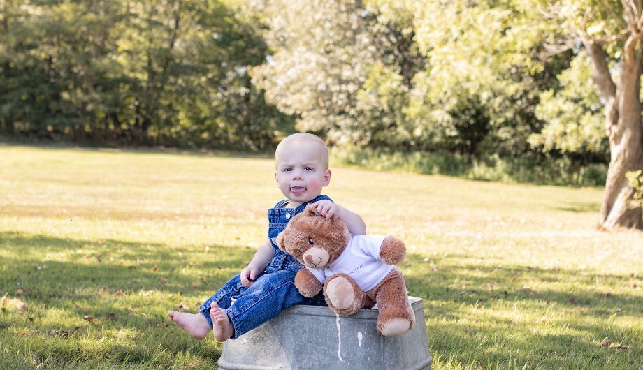 Wyatt sat outside with his teddy bear.